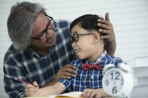 Older teachers are teaching students to do homework, education concept