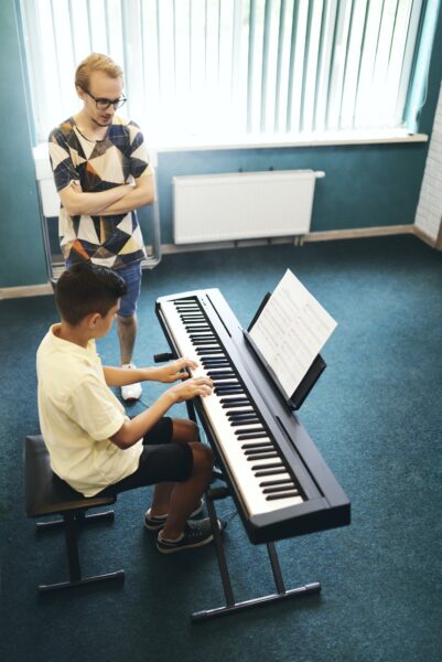 Teacher and student in the classroom of music school