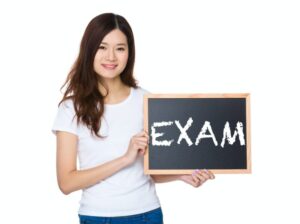 Woman with the chalkboard showing a word exam