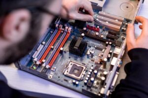 cropped image of man fixing motherboard