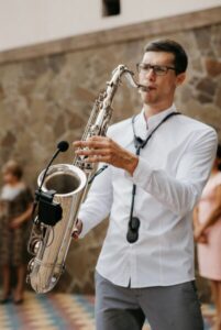 musician saxophonist plays chrome saxophone