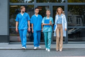teacher walking with multicultural students at medical university