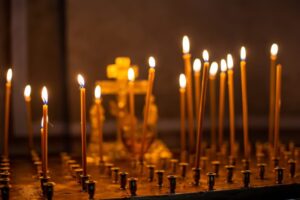 candles are lit for repose. on a square metal table - requiem services.