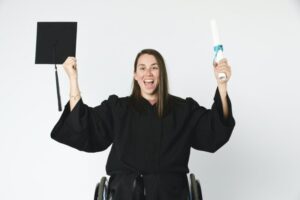 Happy girl in a wheelchair holding her diploma