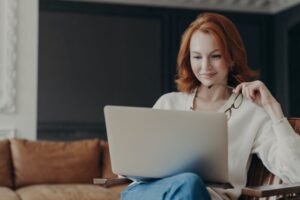 Happy skilled ginger woman teacher works distantly,