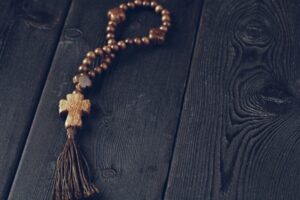 wooden cross on wood background