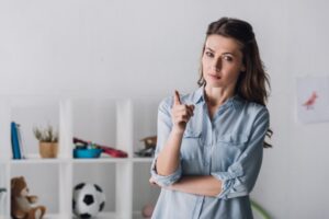 adult woman pointing at camera with sceptic look