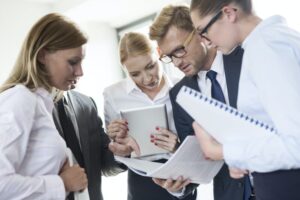 Business people reading in booklet
