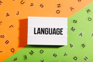 Language text in light box on duo color orange and green background with random letters