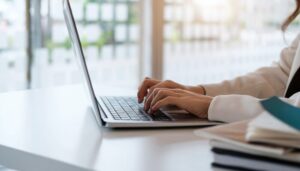 Close up of businesswoman or accountant working on laptop computer for calculate business data