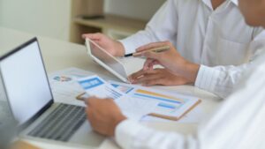 Executives with tablet are evaluating the situation of company to resolve impact of virus outbreak.