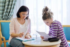 Pre-adolescent girl at consultation with social worker in office