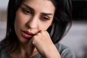 close up of injured woman with bruise touching face, domestic violence concept