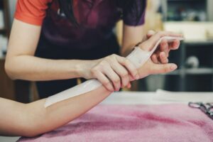 Therapist making asissistive device for immobilize patient hand. Splint service for hand injury reha