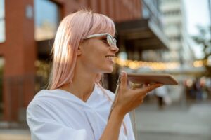 Cheerful young woman talking on mobile phone outdoors