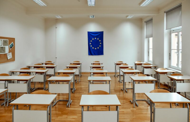 Empty school classroom with european union flag on wall.