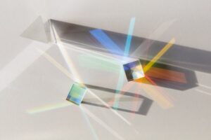 Glass geometric figures prisms with light diffraction and shadows
