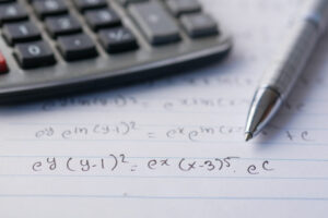 Hand writing algebra equations on a paper