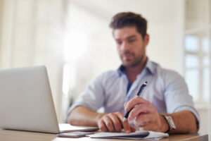 Businessman at home office taking notes