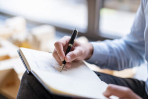 Close-up of businessman taking notes in office
