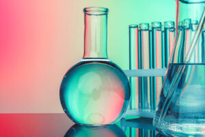 Laboratory chemistry glassware on green toned background