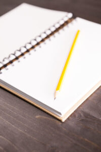 Open notebook with a pencil in it