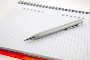 pen and paper orange notebook