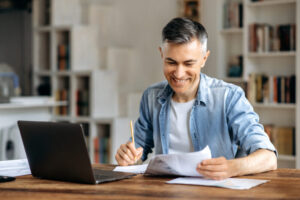 Satisfied successful confident mature gray-haired caucasian businessman, manager working at office