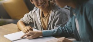 Tutor helping a student with his homework