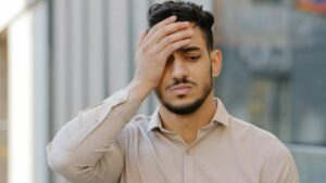 Outdoors male portrait sad hispanic latin man young bearded guy upset frustrated stressful feeling