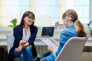 Pre-teen girl at therapy meeting with psychologist