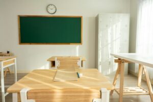 Shot of empty classroom with chairs under desks in elementary school.