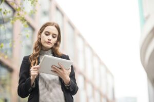 Businesswoman in city using digital tablet