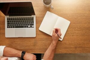Man writing notes in personal notebook