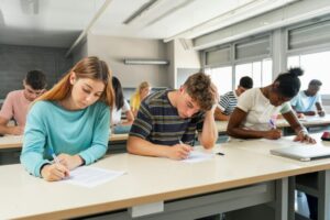 Multi ethnic teenager students taking exam at High School