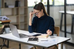 Asian women sitting in an office With stress and eye strain Tired, portrait of sad unhappy tired