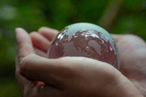 Crystal globe on hand. Environmental ESG concept. Society and Governance Sustainable global