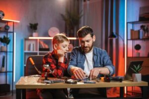 Man and boy using child designer for physics experiment