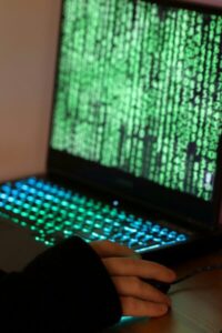 Collection of information. Man at work on a laptop. Computer code.