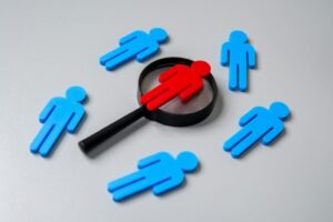 Human figures and magnifying glass.