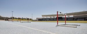 Stadium, hurdles and sports event for exercise, olympics and training with no people, space and moc