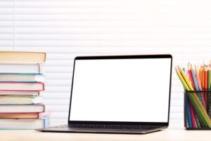 Laptop, books and pencils on desk