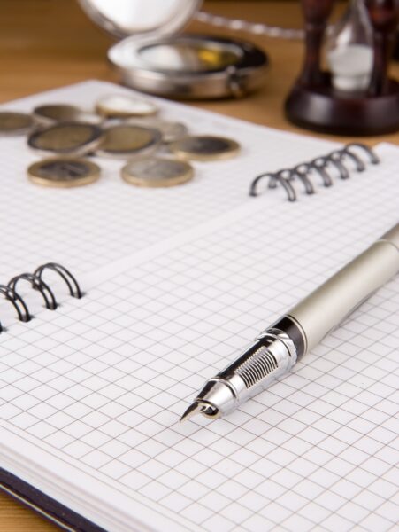 pen and coin on notebook