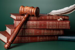 Law gavel and wedding rings on table