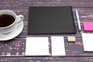 Mock up set of id template, notebook and cup of coffee. Coffee break background