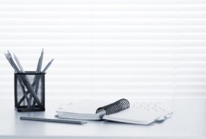 Office workplace with pc, notepad and pencils